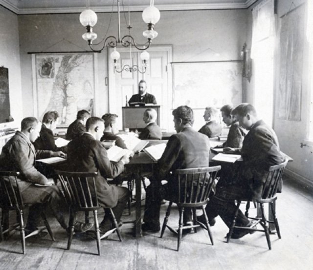 A group of men sitting around a round table