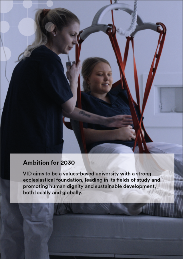 To studenter øver på å bruke en pasientheis. Tekst: Ambisjon for 2030. VID skal være et verdibasert universitet med kirkelig forankring som er ledende innenfor våre fagområder og fremmer menneskelig verdighet og bærekraftig utvikling, lokalt og globalt.