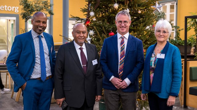 Four people standing on a line