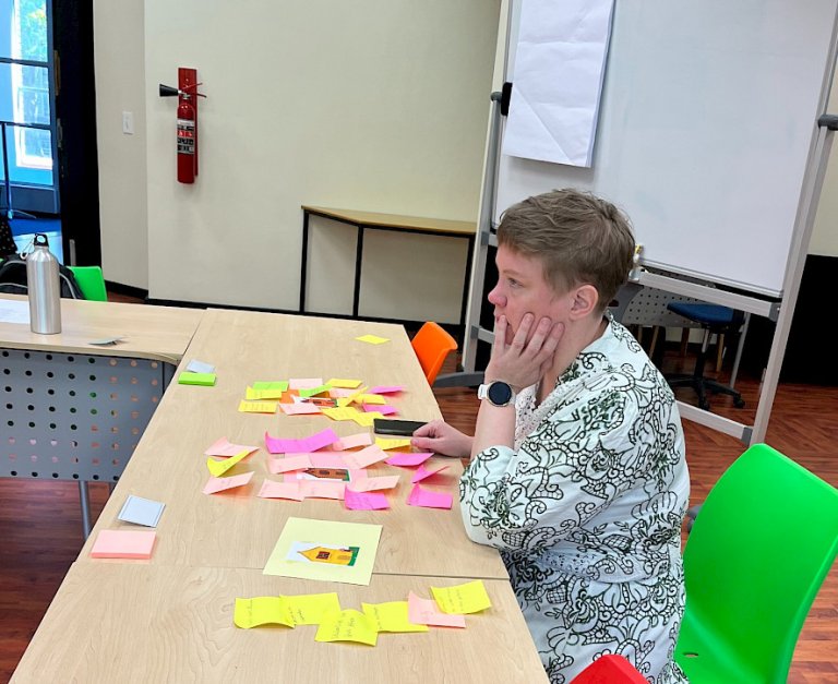 A woman at a desk with post-it notes in front of her