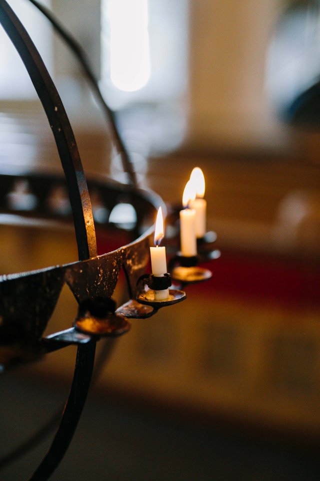 Lit candle in a chapel