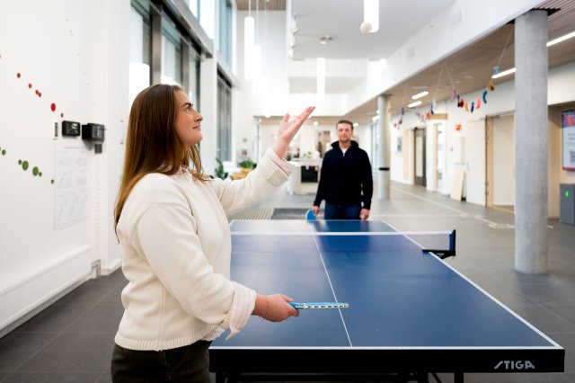 Two students playing table tennis