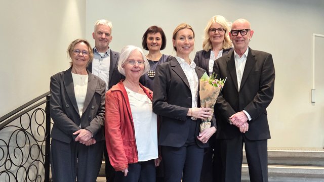 portrett av alle stående i trapp.