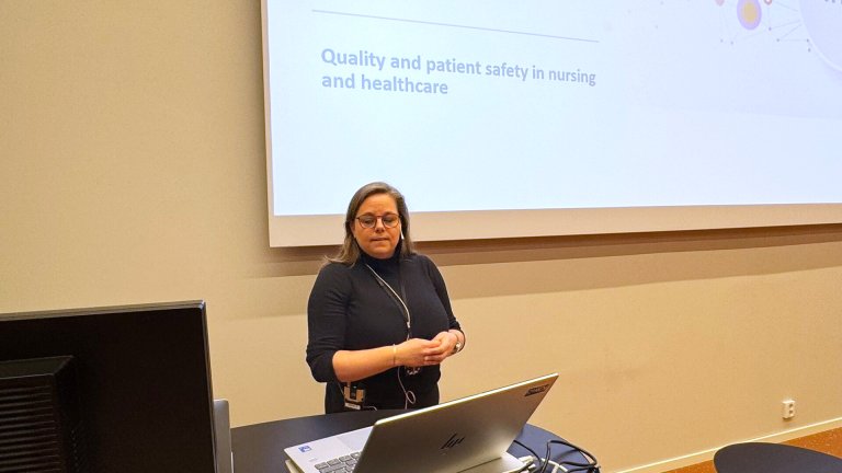 Anine som står og snakker foran powerpoint.