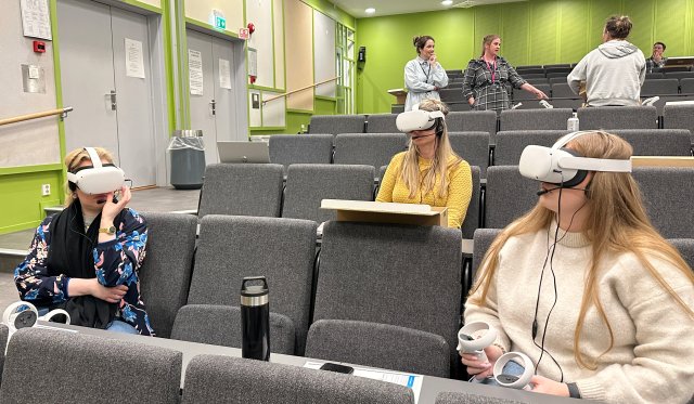 En gruppe elever med VR-briller i et auditorium