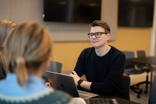 To studenter på et bibliotek sitter og leser
